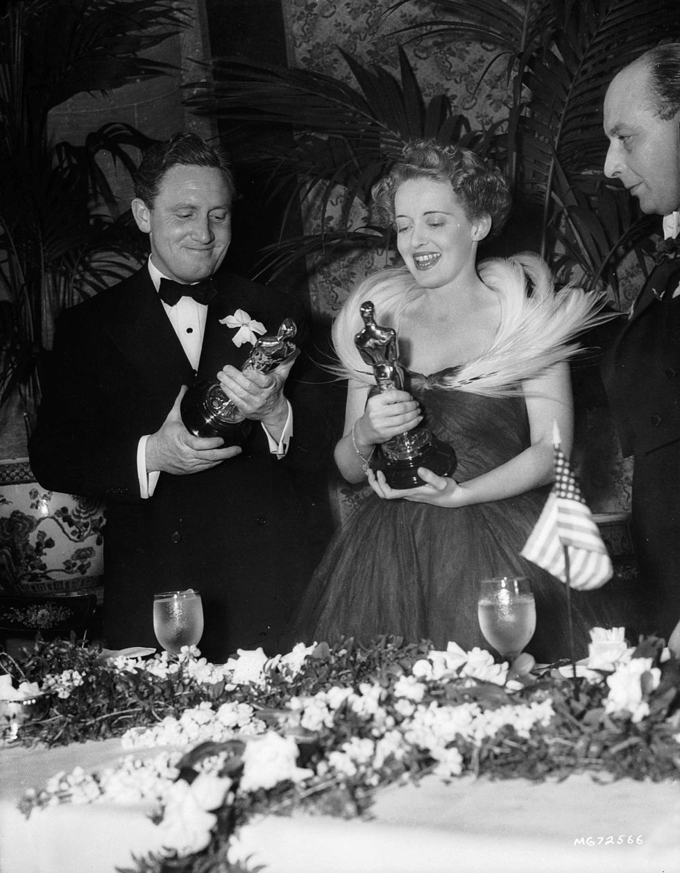 <p>To accept her Best Actress award for <i data-redactor-tag="i">Jezebel</i>, Bette Davis opted for&nbsp;a&nbsp;simple frock with a tulle skirt and a dramatic feathered neckline. Spencer Tracy, picking up his Best Actor award for <i data-redactor-tag="i">Boys Town</i>, wore a black tuxedo, of course.<span class="redactor-invisible-space" data-verified="redactor" data-redactor-tag="span" data-redactor-class="redactor-invisible-space"></span></p>
