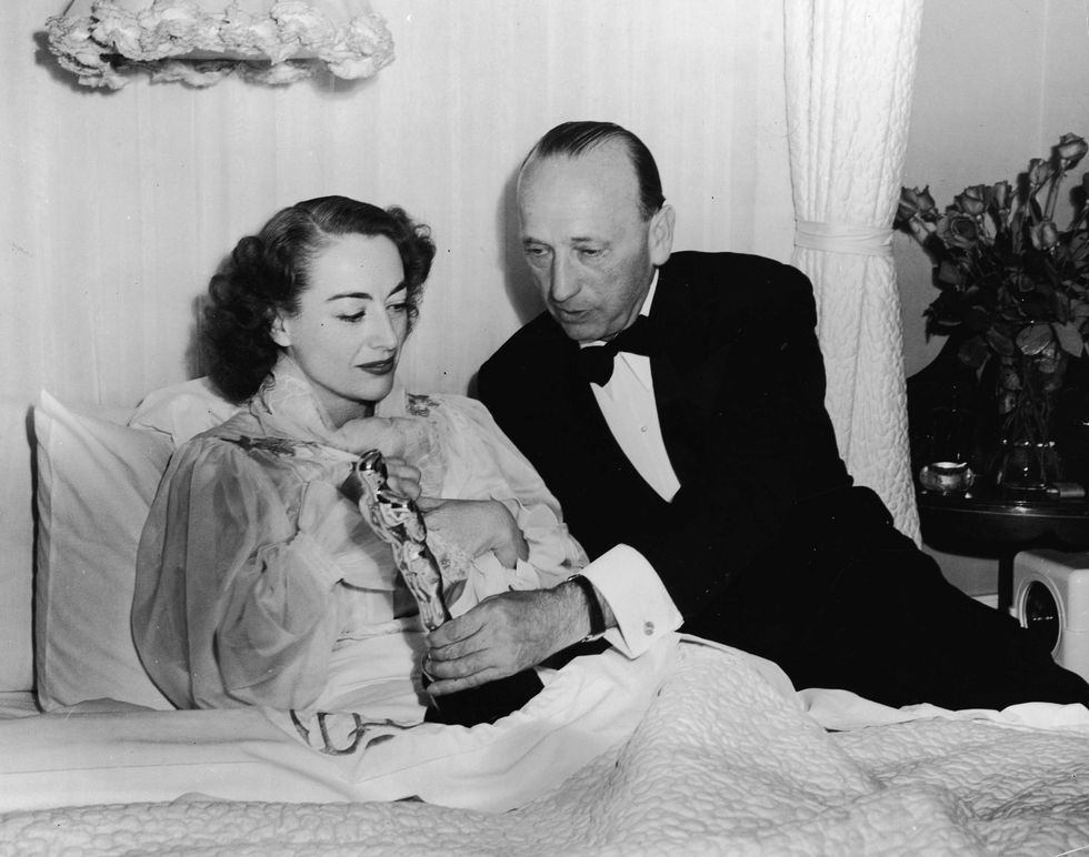 <p>Joan Crawford accepts the award for Best Actress for <i data-redactor-tag="i">Mildred Pierce</i> while she recuperates from a mysterious illness (one rumored to have been caused by a strong reluctance to lose in public to the odds-on favorite Ingrid Bergman).<span class="redactor-invisible-space" data-verified="redactor" data-redactor-tag="span" data-redactor-class="redactor-invisible-space"></span></p>