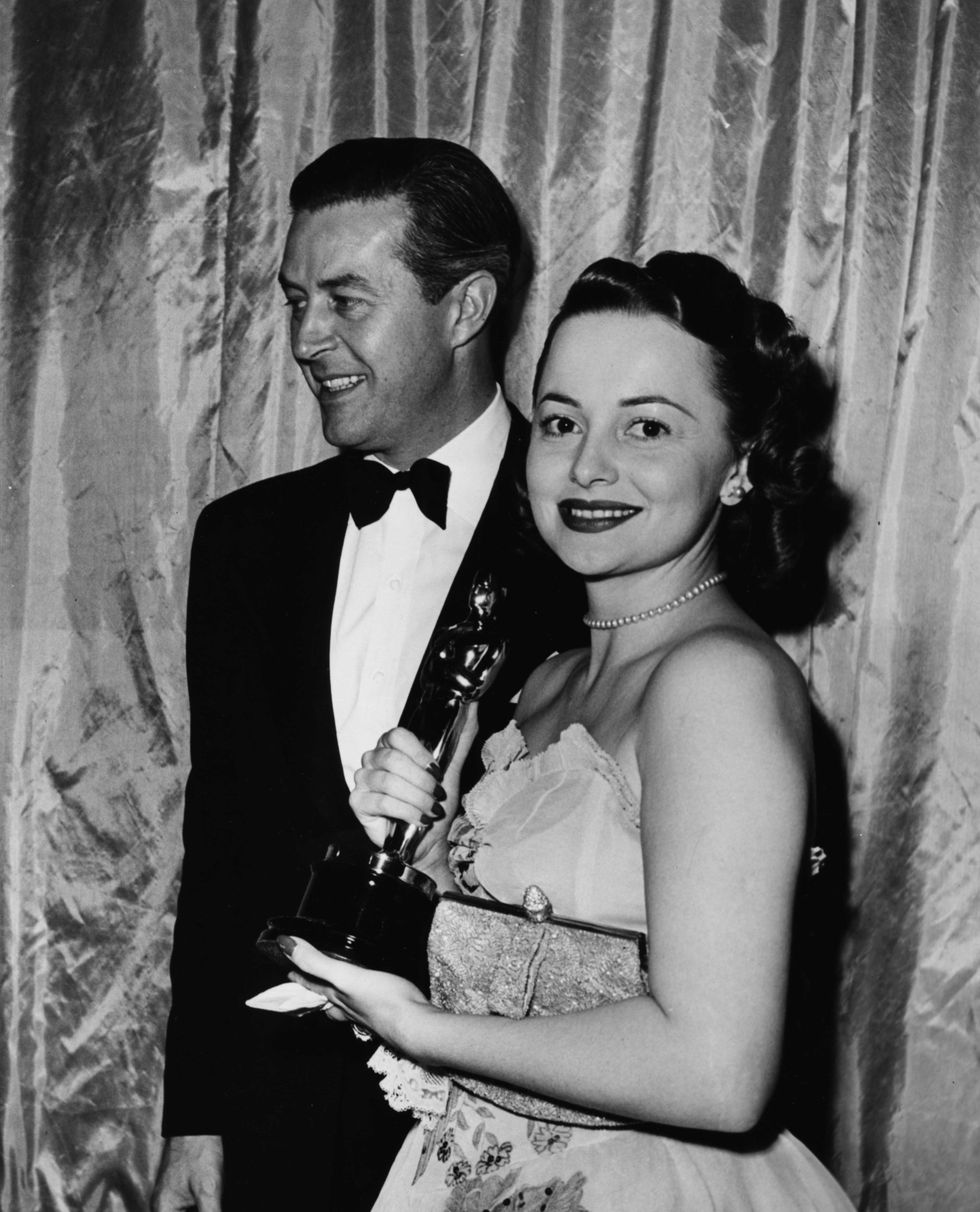 <p>Olivia de Havilland, clutching her evening bag, picks up her Best Actress award from presenter Ray Milland for her film <i data-redactor-tag="i">To Each His Own</i>.<span class="redactor-invisible-space" data-verified="redactor" data-redactor-tag="span" data-redactor-class="redactor-invisible-space"></span></p>