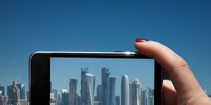 Finger, Tower block, City, Technology, Metropolitan area, Thumb, Urban area, Commercial building, Display device, Azure, 