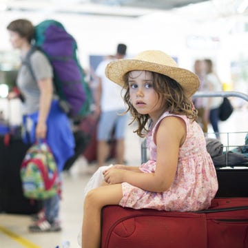 Hat, Fashion accessory, Sun hat, Sitting, Fashion, Street fashion, Bag, Luggage and bags, Long hair, Child model, 