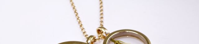 Metal, Amber, Pendant, Jewellery, Brass, Circle, Chain, Symbol, Locket, Material property, 