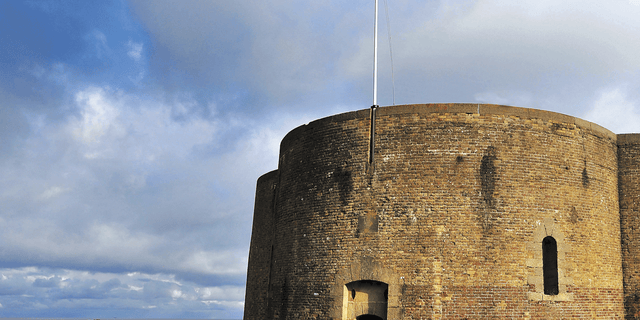 Wall, Brick, Land lot, Rural area, Brickwork, Iron, Stone wall, Historic site, Fortification, Cylinder, 