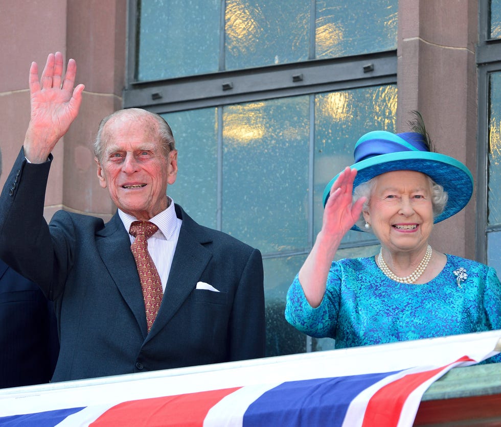 Hat, Dress shirt, Coat, Outerwear, Happy, Flag, Facial expression, Collar, Suit, Sun hat, 