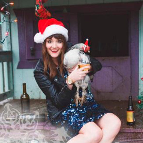 Holiday, Costume accessory, Winter, Dress, Sitting, Costume hat, Bottle, Toy, Christmas, Fur, 