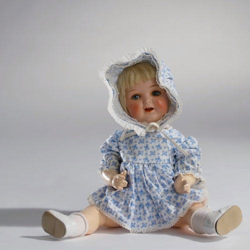 Baby & toddler clothing, Sitting, Toy, Doll, Costume accessory, Baby toys, Embellishment, Sock, Bonnet, Figurine, 
