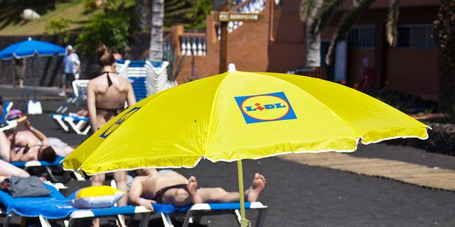 Yellow, Umbrella, Outdoor furniture, Sunlounger, Sun tanning, Swimwear, 