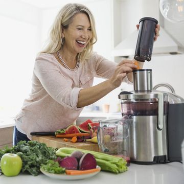 woman using juicer