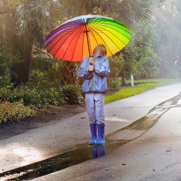Umbrella, People in nature, Rain, Orange, Sky, Yellow, Fashion accessory, Tree, Fun, Grass, 