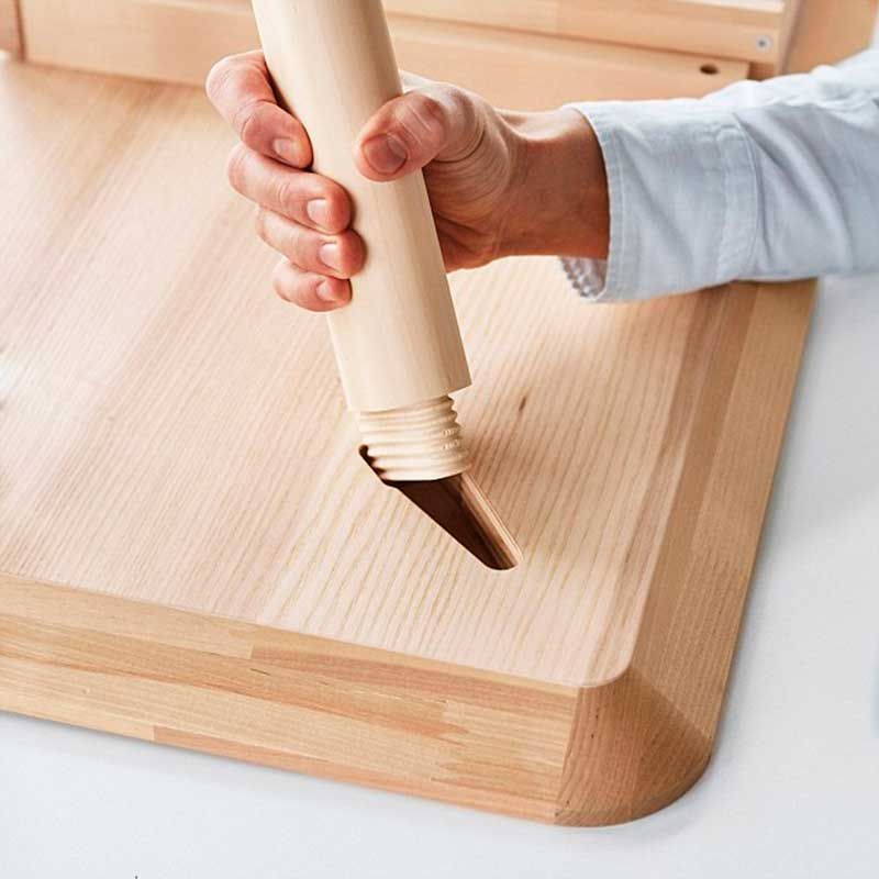 Rolling pin, Wood, Table, Wood stain, Cutting board, Hand, Floor, Hardwood, Furniture, Kitchen utensil, 