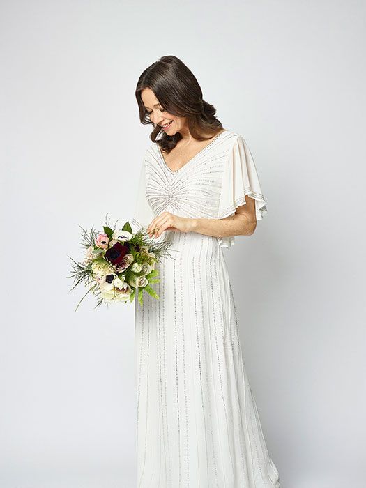Sleeve, Shoulder, Dress, Textile, Bridal clothing, White, Petal, Bouquet, Wedding dress, Bridal accessory, 