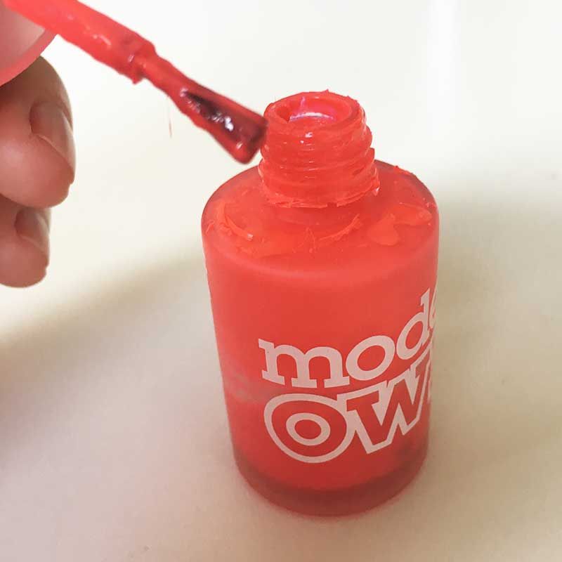 Red, Nail, Bottle, Nail care, Finger, Nail polish, Material property, Plastic bottle, Water bottle, Cosmetics, 