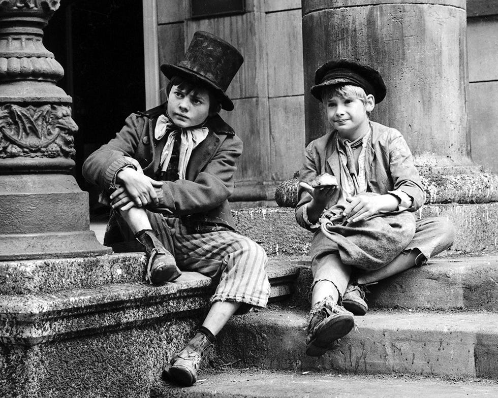 Leg, Hat, Monochrome, Trousers, Shoe, Human leg, Photograph, Sitting, Monochrome photography, Outerwear, 