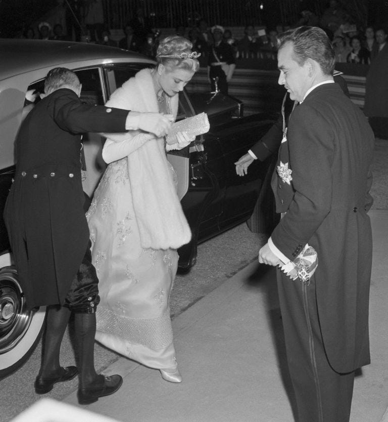 Photograph, Snapshot, Standing, Luxury vehicle, Black-and-white, Event, Dress, Gesture, Monochrome, Suit, 