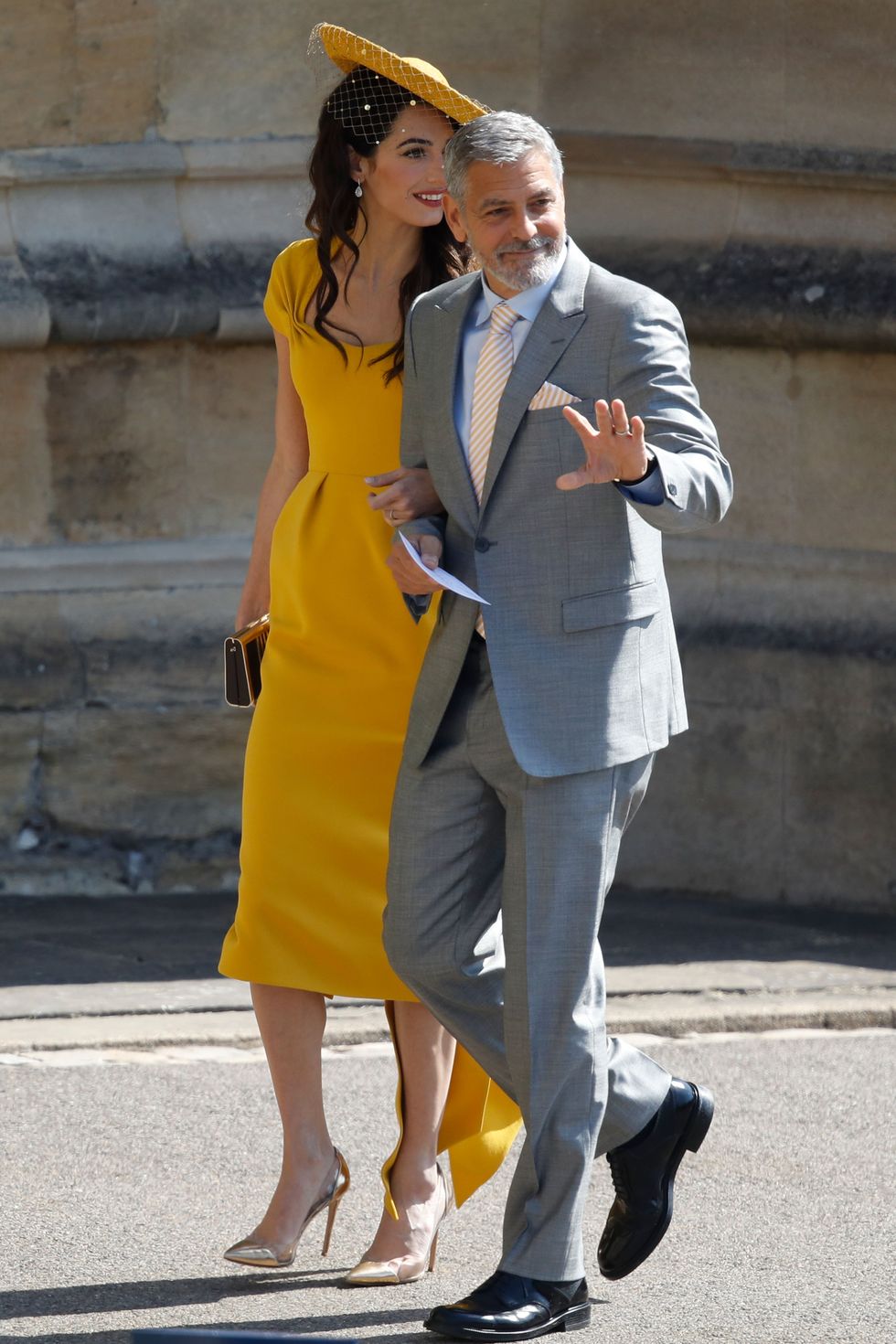 Yellow, Fashion, Street fashion, Suit, Footwear, Standing, Interaction, Dress, Outerwear, Gesture, 