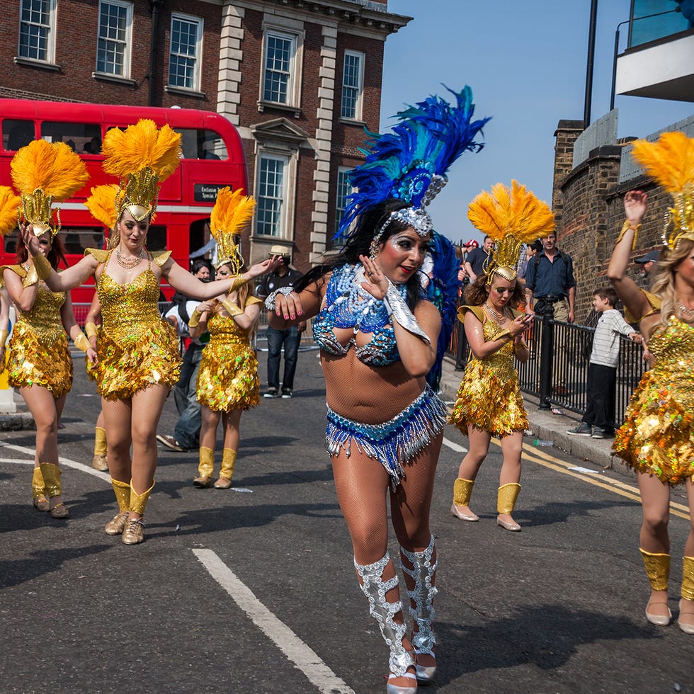 Footwear, Performing arts, Event, Entertainment, Carnival, Headgear, Thigh, Public event, Dance, Muscle, 