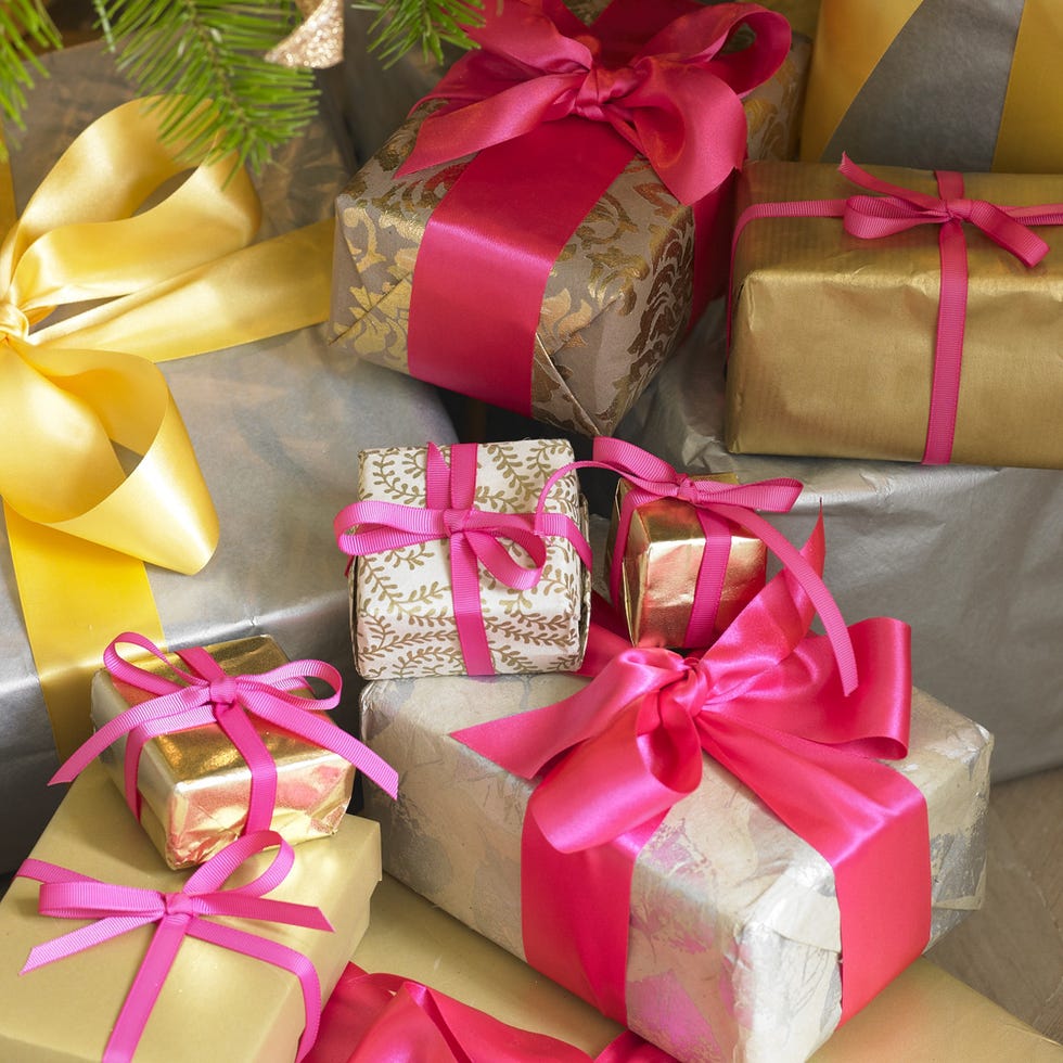Red, Ribbon, Gift wrapping, Present, Party favor, Paper product, Gold, Material property, Packing materials, Packaging and labeling, 
