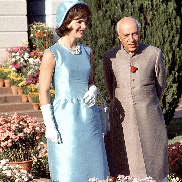 Clothing, Dress, Outerwear, Coat, Formal wear, Flowerpot, Gown, Tradition, Wedding dress, Necklace, 