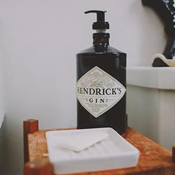 Bottle, Distilled beverage, Wood stain, Symbol, Home accessories, Still life photography, Glass bottle, Label, Varnish, 