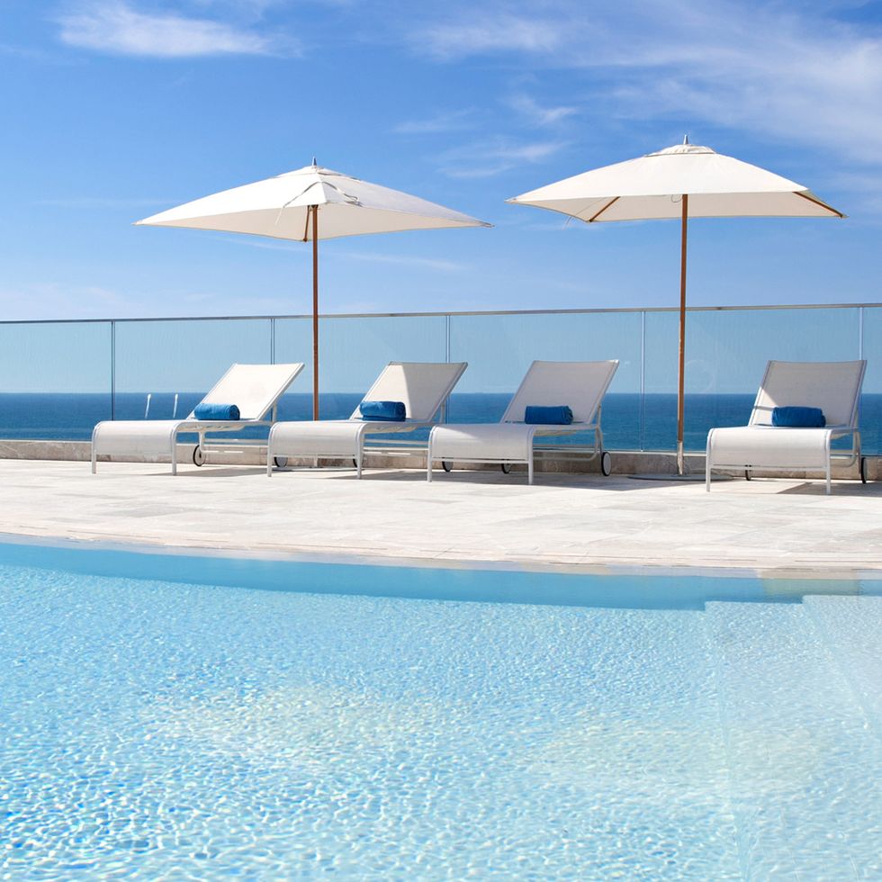 Blue, Sunlounger, Outdoor furniture, Aqua, Umbrella, Resort, Shade, Azure, Turquoise, Swimming pool, 