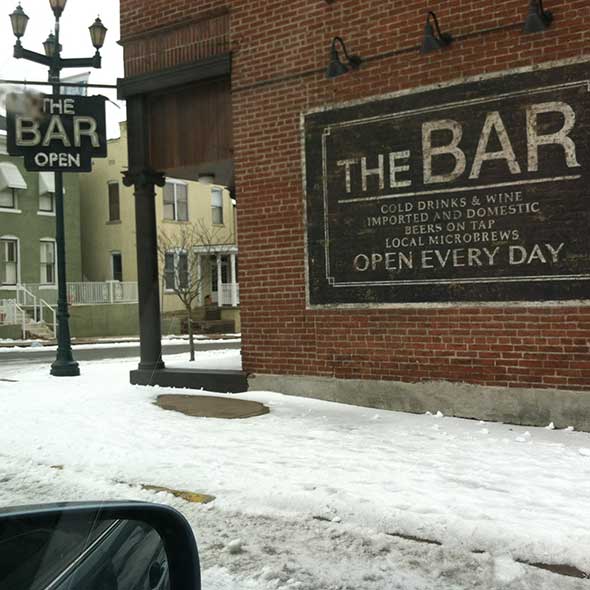 Street light, Winter, Automotive mirror, Signage, Brick, Brickwork, Snow, Freezing, Pole, Light fixture, 