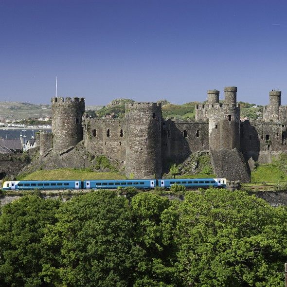 Architecture, Rolling stock, Railway, Wall, Landmark, Train, Castle, History, Railroad car, Ancient history, 