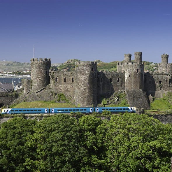 Architecture, Rolling stock, Railway, Wall, Landmark, Train, Castle, History, Railroad car, Ancient history, 