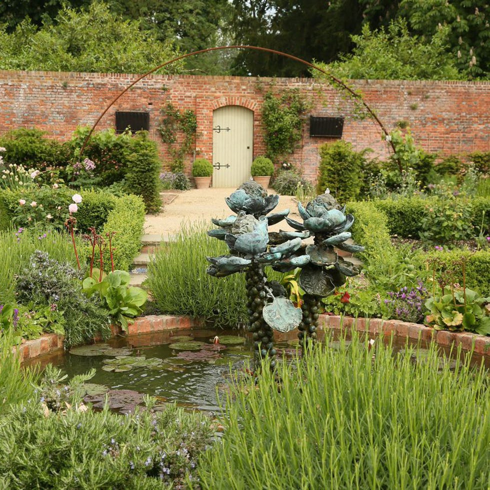 Plant, Garden, Shrub, Botany, Water feature, Groundcover, Grass family, Sculpture, Yard, Lawn ornament, 