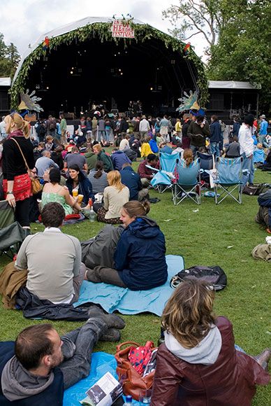 Crowd, Sitting, Audience, Sharing, Stage, Backpack, Lawn, Hoodie, Folding chair, Park, 