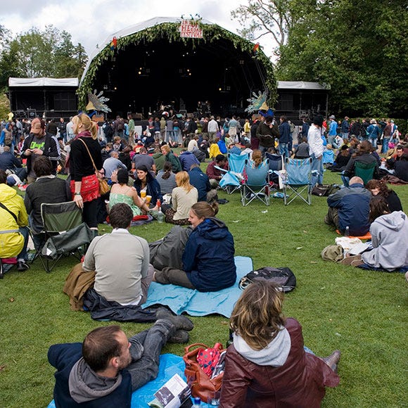 Crowd, Sitting, Audience, Sharing, Stage, Backpack, Lawn, Hoodie, Folding chair, Park, 
