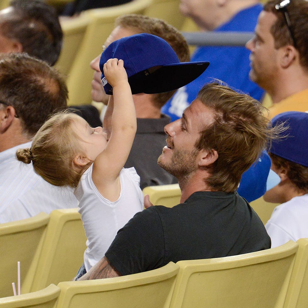 Hair, Ear, Hat, Cap, Interaction, Baseball cap, Gesture, Fan, Beard, Hearing, 