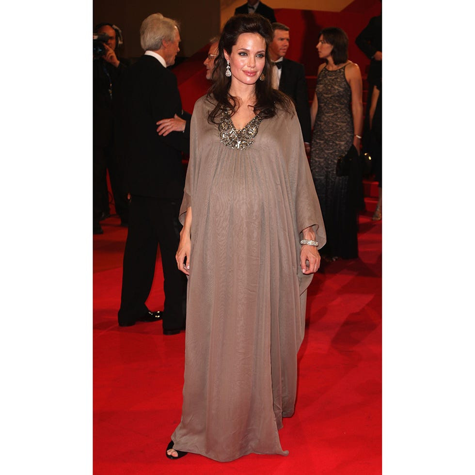 Clothing, Dress, Trousers, Event, Flooring, Coat, Outerwear, Red, Carpet, Formal wear, 