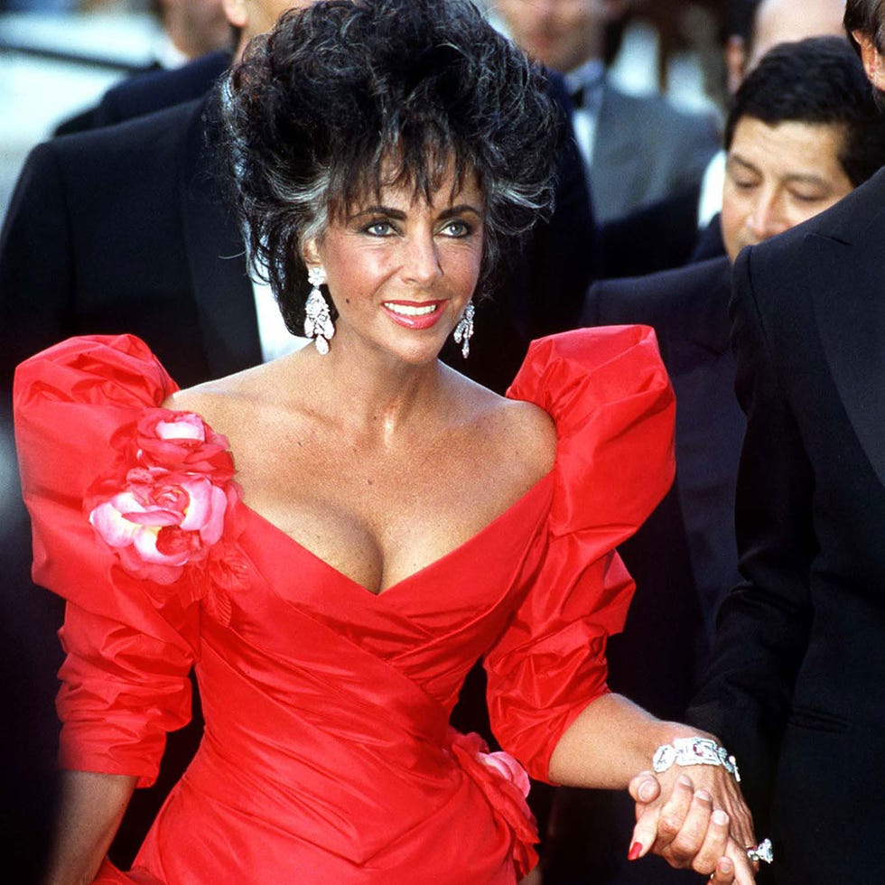 Clothing, Hairstyle, Event, Coat, Outerwear, Dress, Red, Suit, Formal wear, Facial expression, 