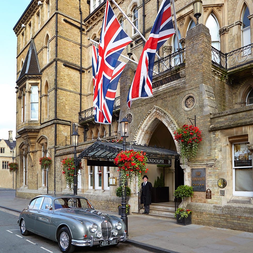 Classic car, Car, Flowerpot, Antique car, Automotive parking light, Flag, Street, Classic, Facade, Luxury vehicle, 