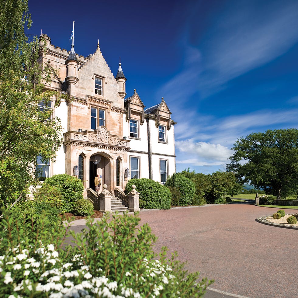 Building, Shrub, Spire, Garden, Steeple, Turret, Groundcover, Stately home, Manor house, Medieval architecture, 