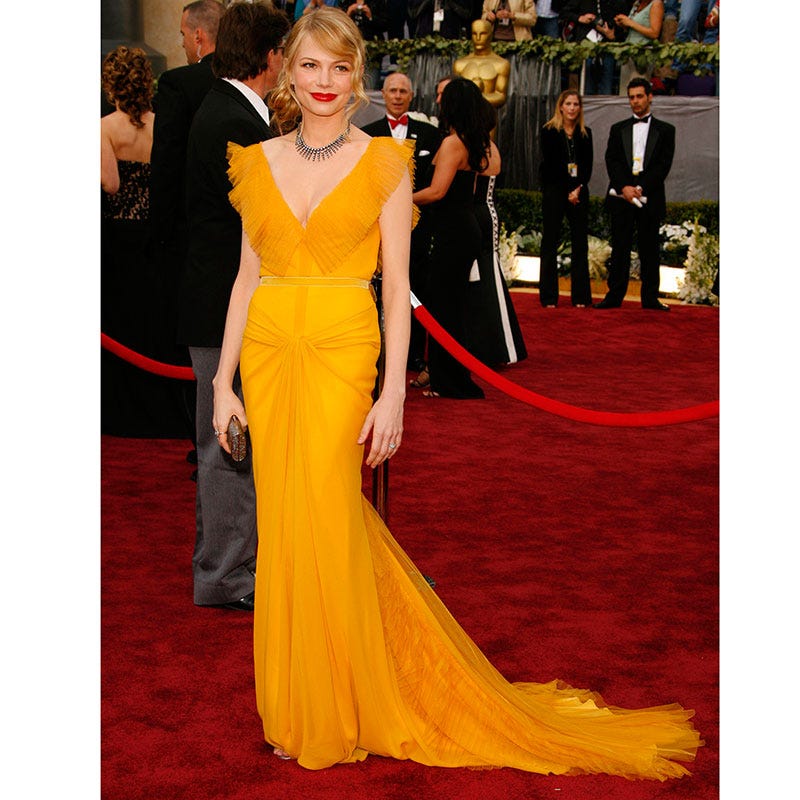 Dress, Clothing, Gown, Red carpet, Carpet, Shoulder, A-line, Yellow, Fashion model, Fashion, 