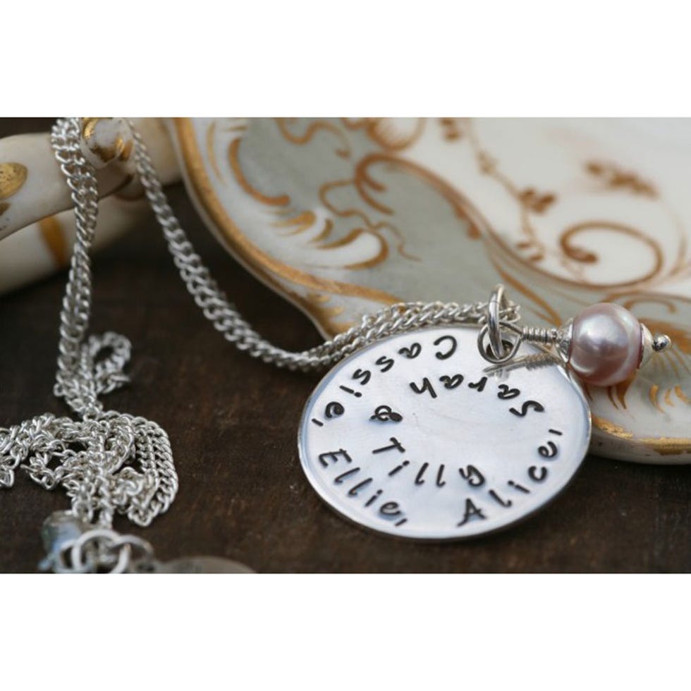 Chain, Metal, Locket, Beige, Still life photography, Natural material, Material property, Circle, Silver, Pocket watch, 