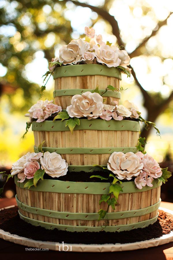 The Cakehaus - Ivory wedding cake with monogram floral plaque, edible lace  and a gypsophila garland supplied by Finesse Floral Designs. 3-tier double barrel  cake standing approx 24