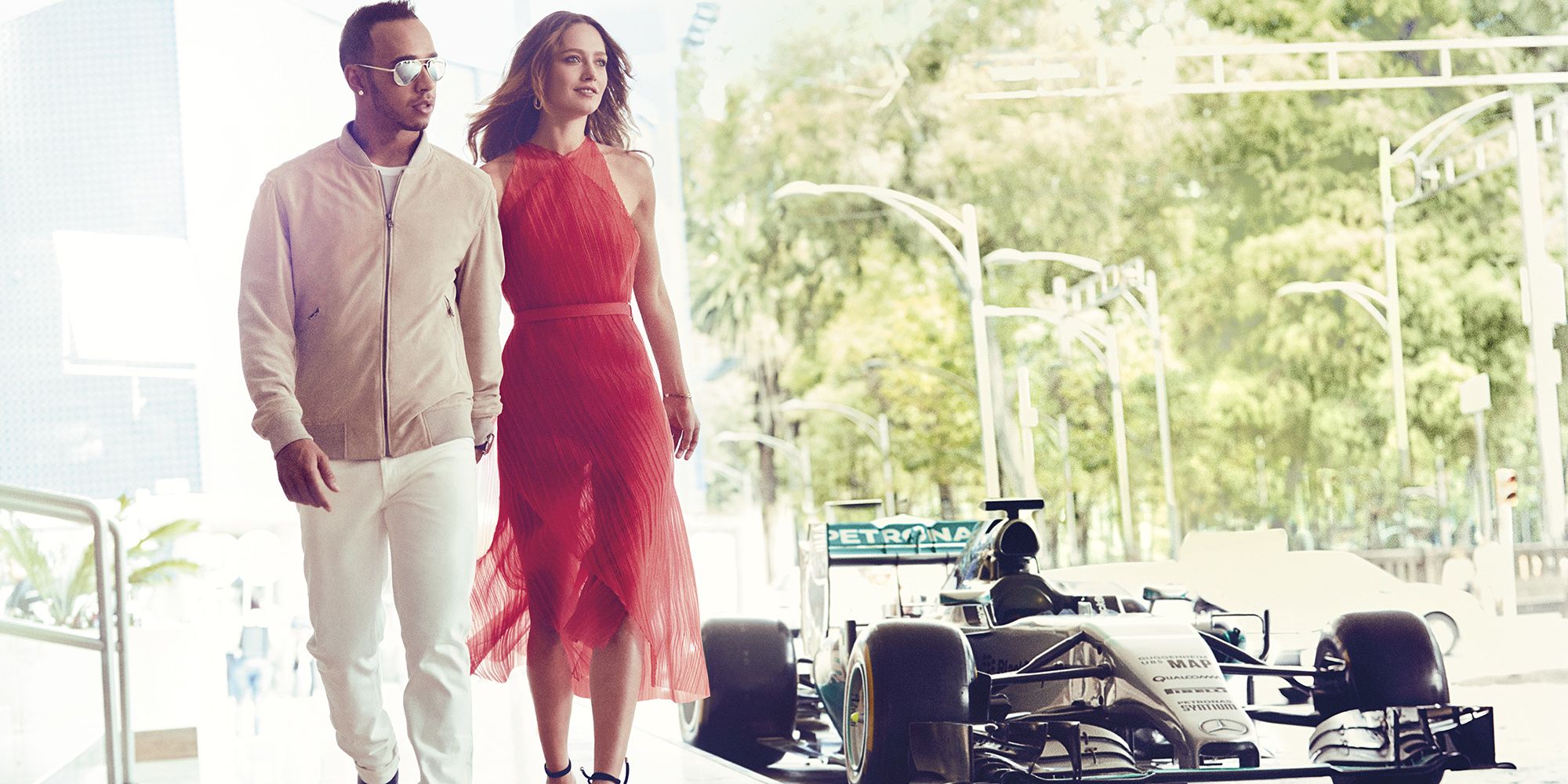 Lewis Hamilton looks dapper as he surrounds himself with gorgeous
