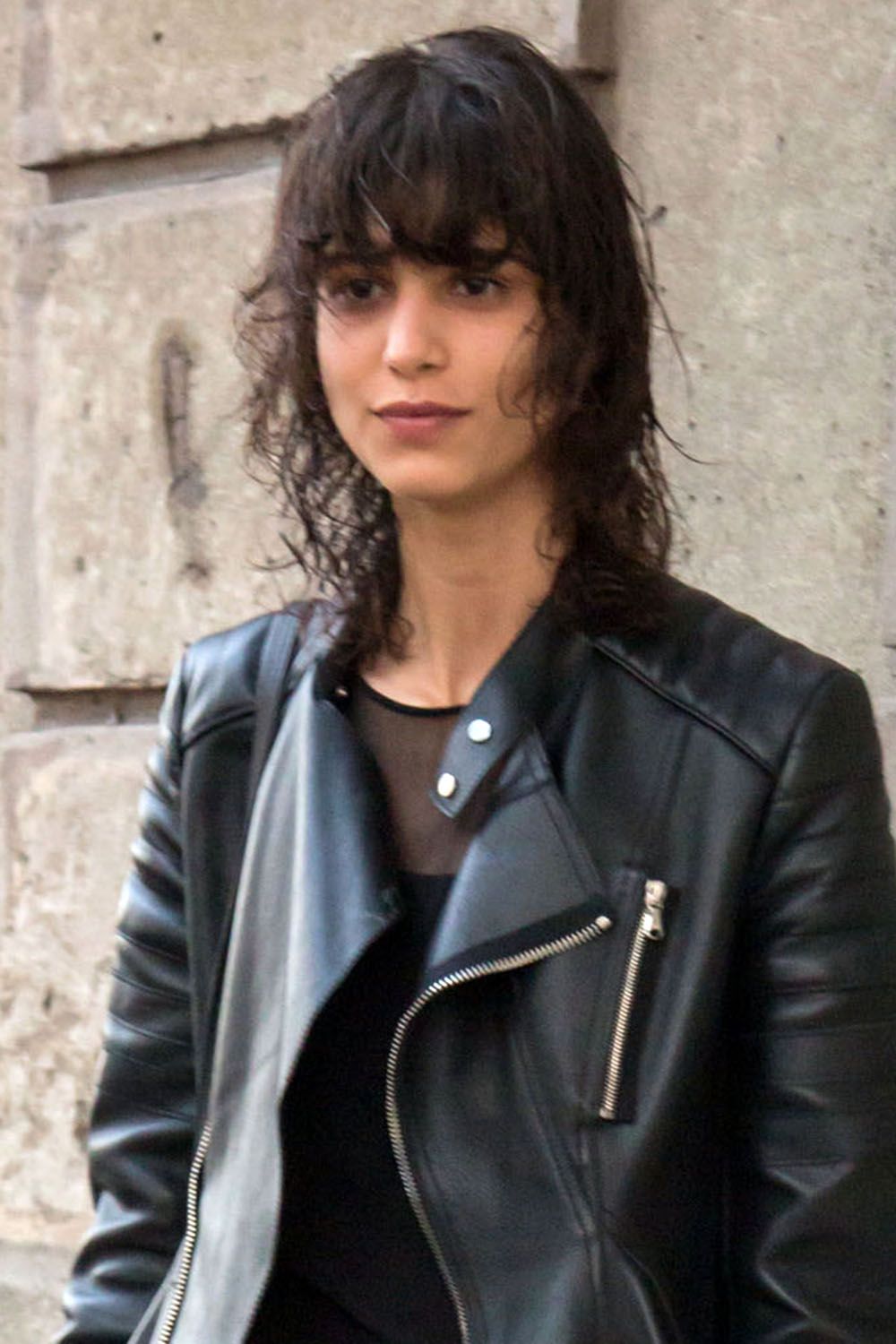 Image of Woman with long shag hair in leather jacket