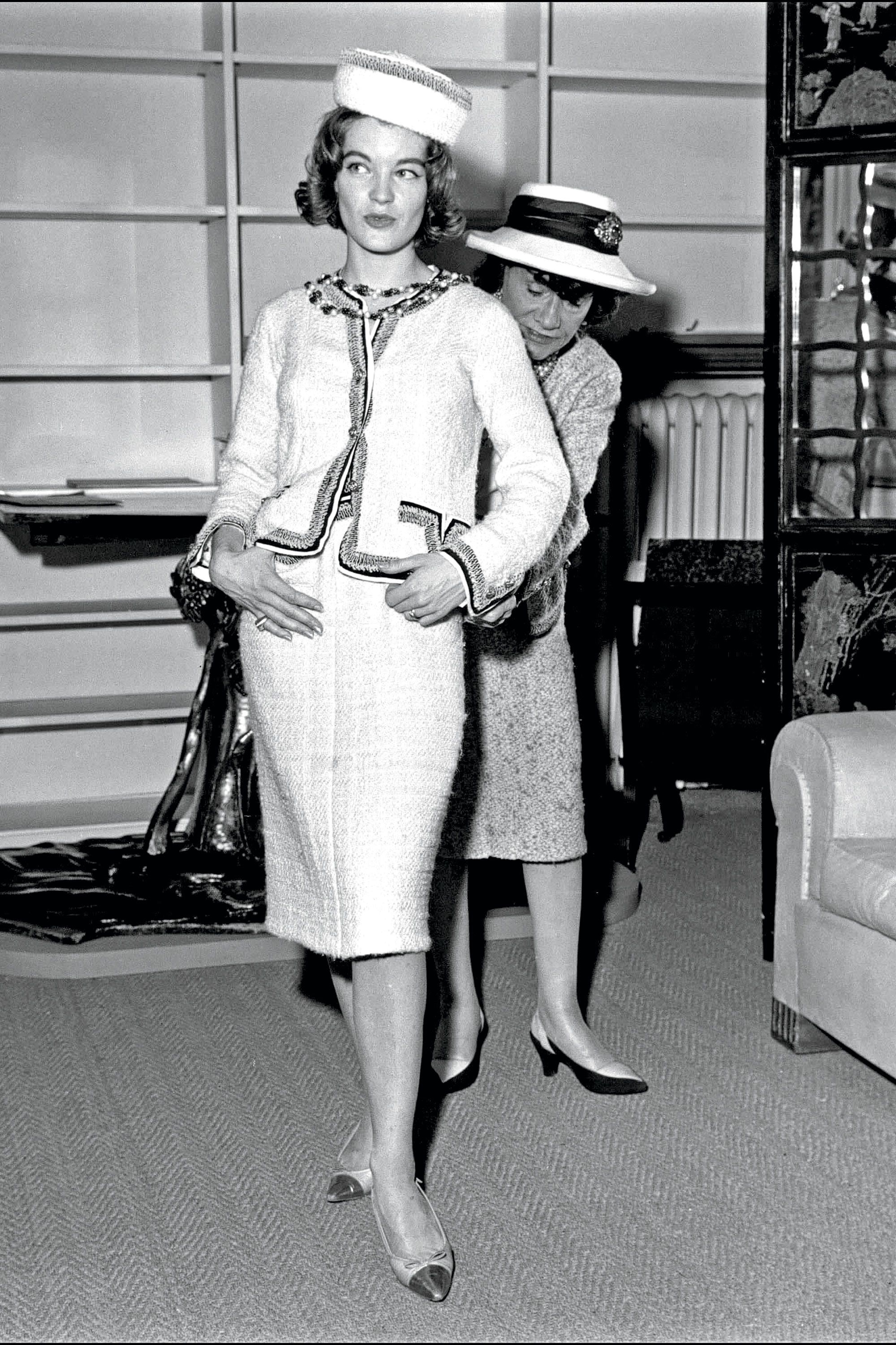 Model is wearing a frothy, tiered party dress by Chanel, 1960