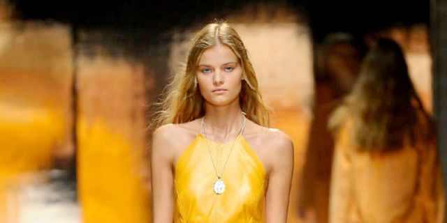 Yellow, Hairstyle, Shoulder, Dress, Jewellery, Fashion model, Style, Amber, Formal wear, Fashion show, 