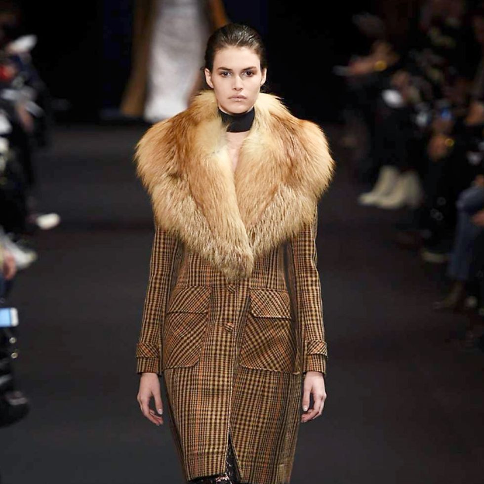 Fashion show, Brown, Shoulder, Textile, Runway, Outerwear, Fashion model, Style, Jacket, Fur clothing, 