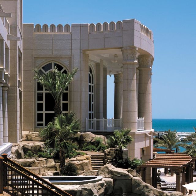 Real estate, Column, Arch, Shade, Classical architecture, Resort, Tropics, Palm tree, Seaside resort, Balcony, 