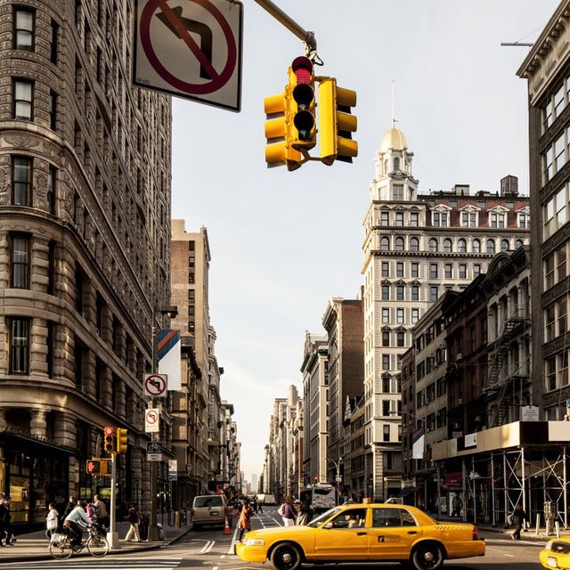 Road, Yellow, Land vehicle, Window, Infrastructure, Street, Neighbourhood, Car, Automotive parking light, Taxi, 