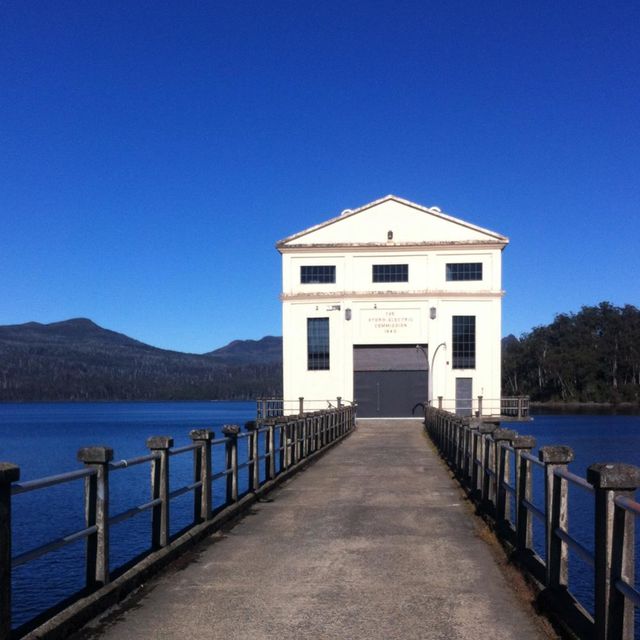 Blue, Guard rail, Door, Landmark, House, Channel, Azure, Reservoir, Iron, Mountain range, 
