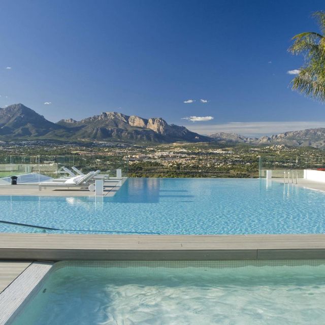 Swimming pool, Water, Mountain range, Aqua, Mountain, Real estate, Hill, Azure, Teal, Resort, 