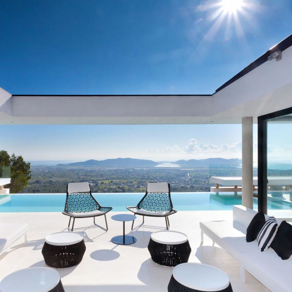 Real estate, Resort, Azure, Shade, Swimming pool, Lens flare, Villa, Sun, Daylighting, Outdoor furniture, 