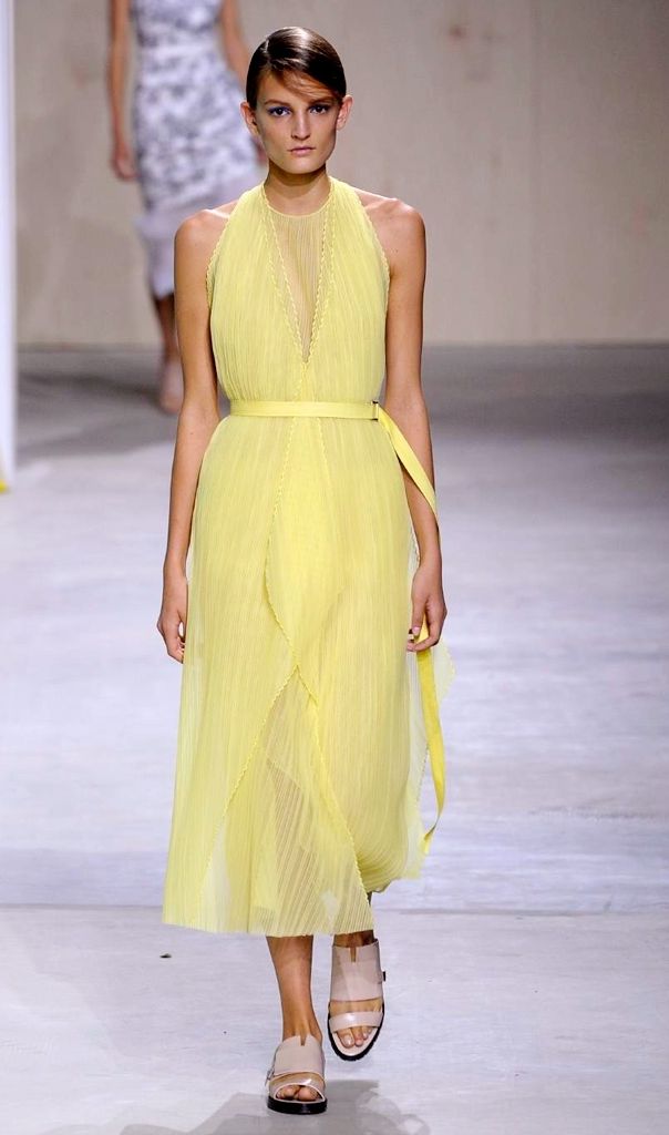 Clothing, Yellow, Human body, Shoulder, Joint, Fashion show, Dress, Floor, Formal wear, One-piece garment, 