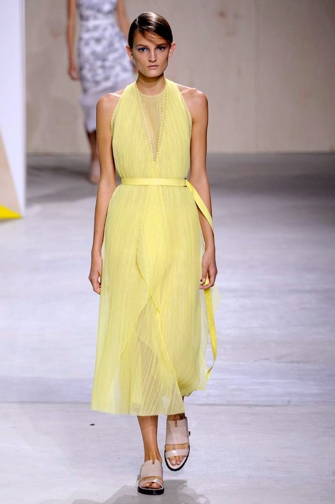 Clothing, Yellow, Human body, Shoulder, Joint, Fashion show, Dress, Floor, Formal wear, One-piece garment, 